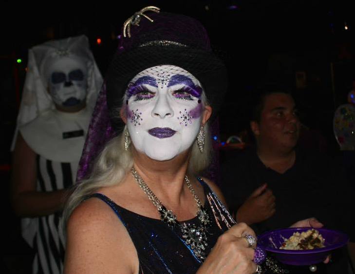 Sister Hecate of the Bodacious Tatas enjoys the mashed potato bar at the 2014 Purple Party.