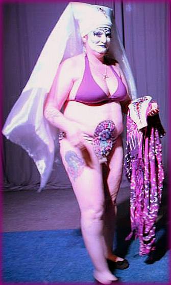 Sister Develyn Angels showing her ileostomy pouch during a stage performance at the first Purple Party in 2014.