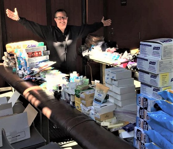 Saint Tiger showcasing the piles of toiletries gathered by the STAT program for distribution to San Diego's homeless population.